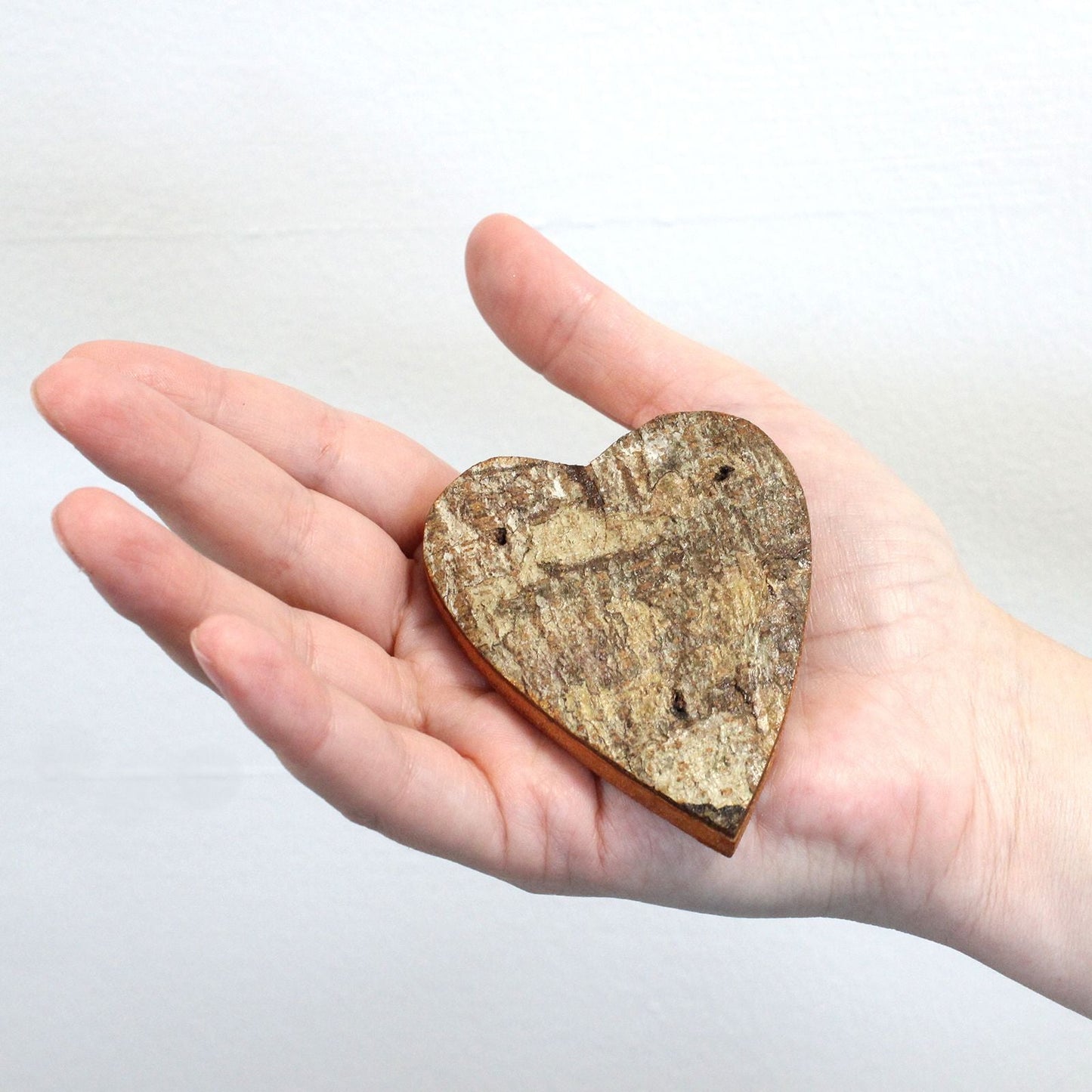 Alt Tag: Albasia Wood Rustic Bark 'LOVE' Display – Set of 4, rustic bark heart-shaped Albasia wood letter decor held in hand