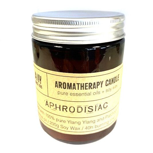 Alt Tag: Uplifting aroma for mindful routines. soy aromatherapy candle in amber glass jar with metal lid, labeled "Aphrodisiac"