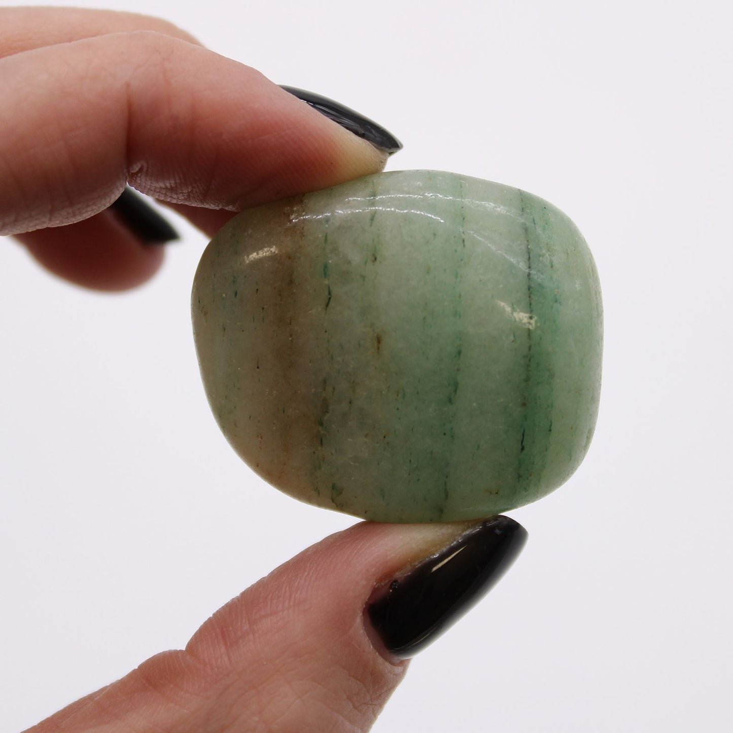 Alt Tag: Aventurine Gemstone Tumble Stones – Bag of 6 polished green aventurine tumble stone held between fingers, close-up