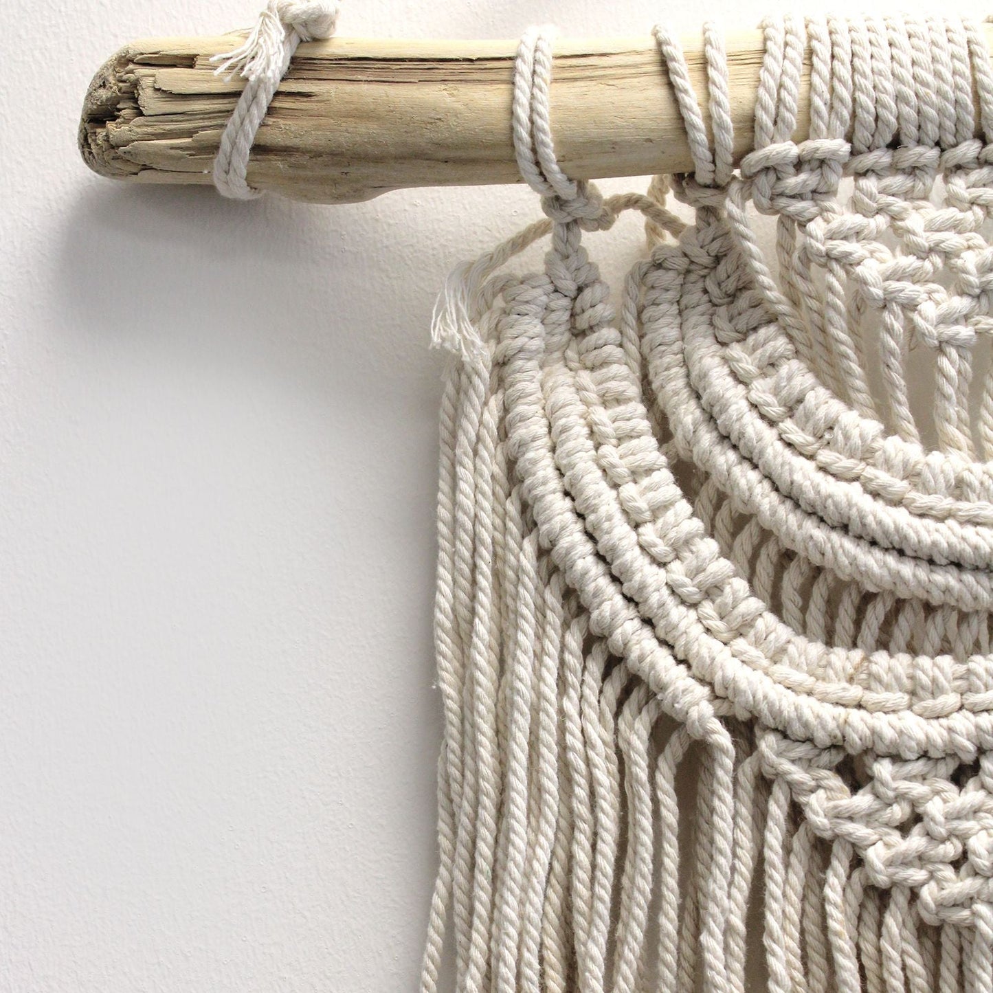 Alt Tag: Cotton Macrame Wall Hanging – 56x44 CM close-up of three waves cotton cord knots on natural wooden dowel