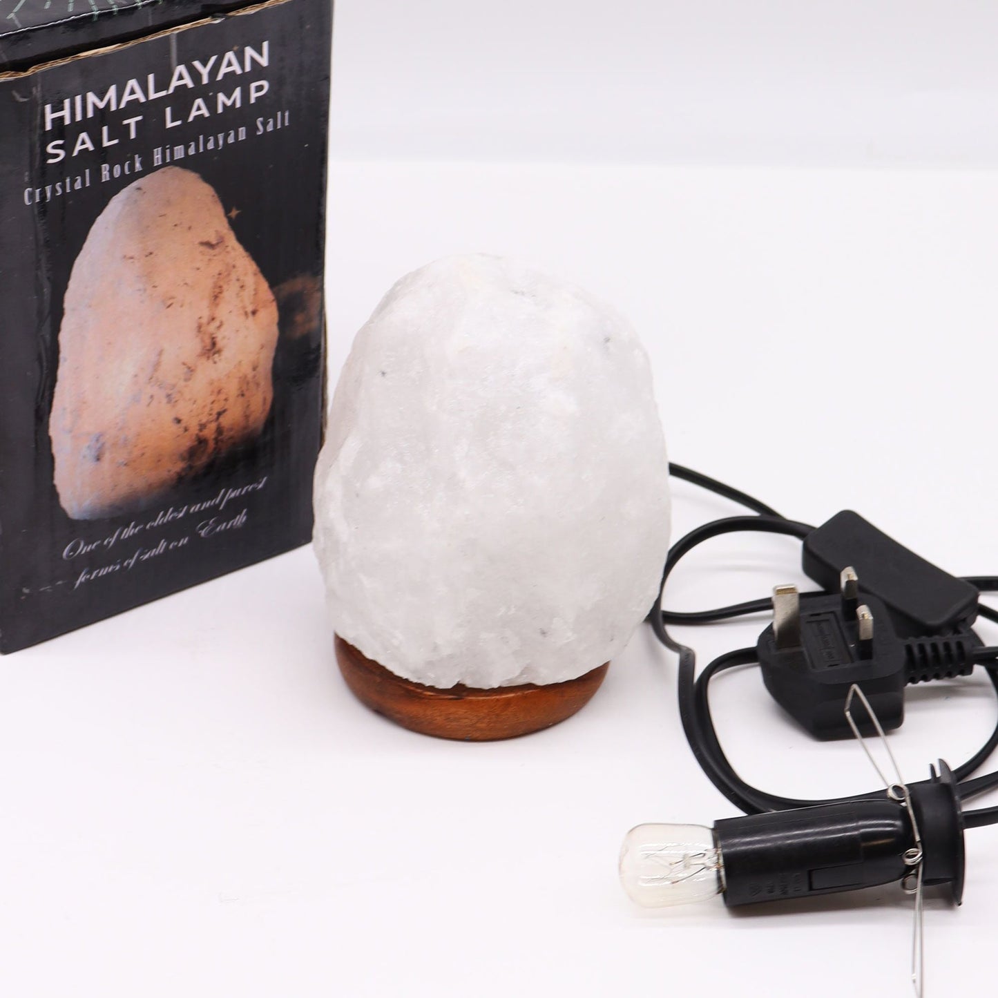 Alt Tag: Crystal Rock Himalayan Salt Lamp – Approx. 1.5–2 KG with wooden base, power cord and bulb, shown with product box