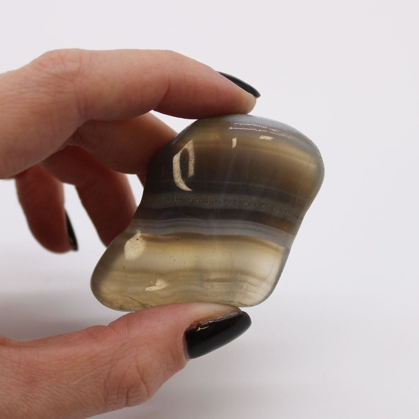 Alt Tag: Grey Agate Gemstone Tumble Stones – 6 Large Pieces, close-up of polished grey agate tumble stone held in hand