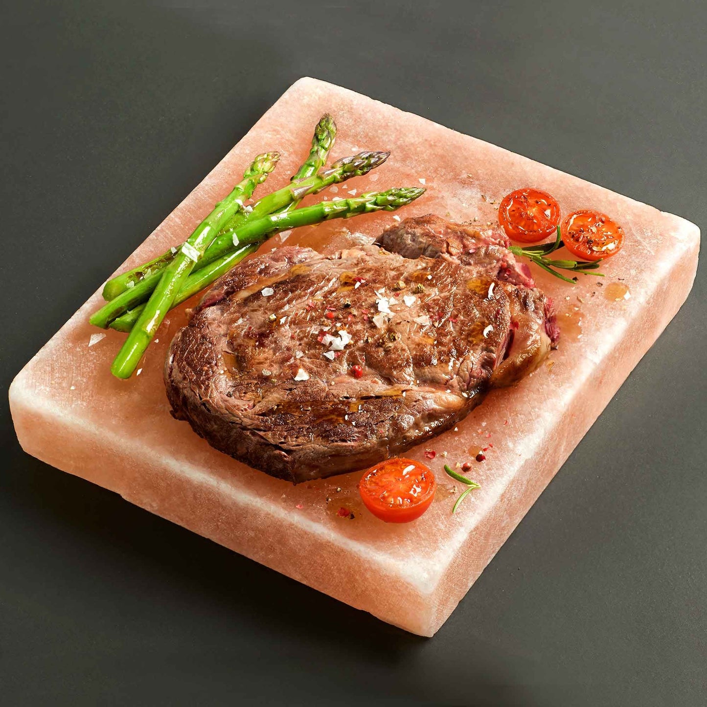 Himalayan Salt Cooking Plate – Square (20 × 20 × 5 CM) with grilled steak, asparagus and cherry tomatoes on pink salt block