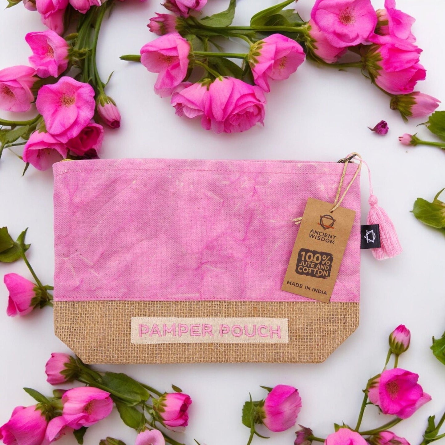 Alt Tag: Jute & Cotton Pamper Pouch – 25x7x15 CM stonewash pink and purple jute-cotton pouch with zipper, flat lay with pink flowers