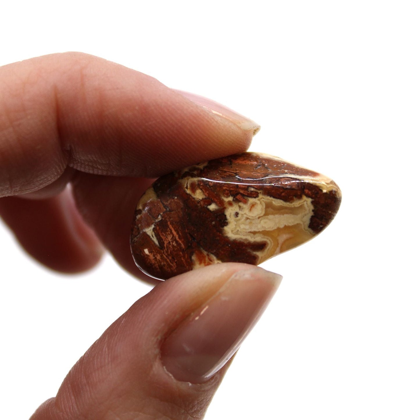 Alt Tag: Light Jasper Tumble Stones – 24 Piece Bag, close-up of polished light jasper tumble stone held between fingers
