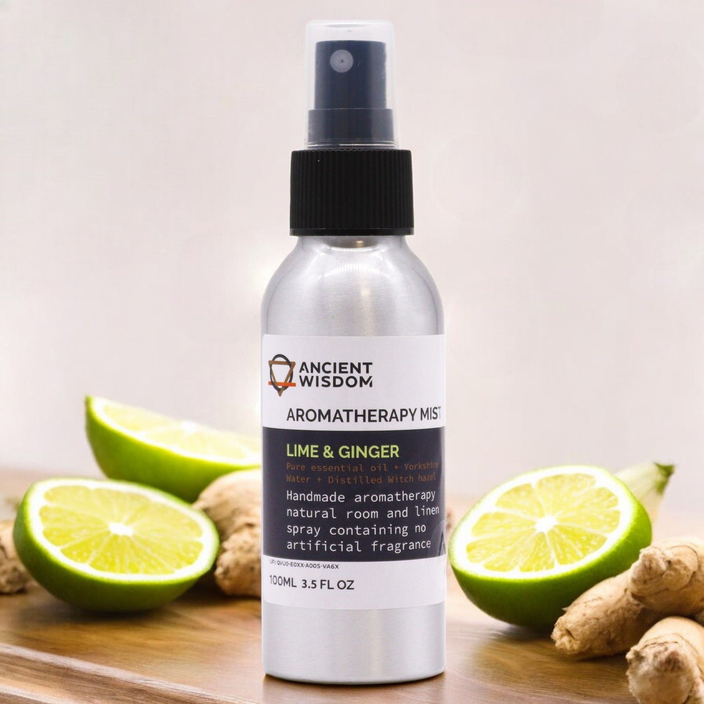 Alt Tag: Lime & Ginger Essential Oil Mist – 100ML aromatherapy spray bottle with fresh limes and ginger on wooden surface