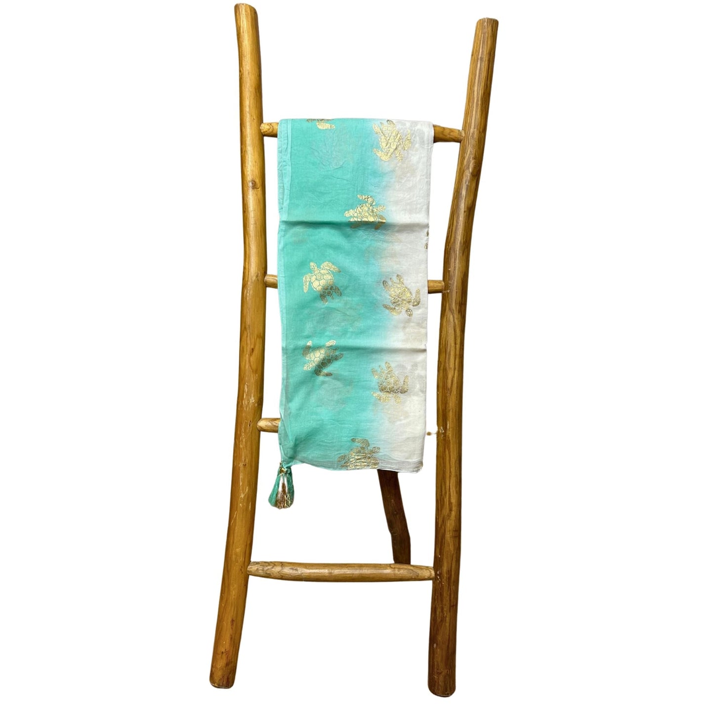 Nomad Sari Pario – White & Turquoise with Gold Turtle Design draped on wooden ladder, white-turquoise fabric with gold turtles