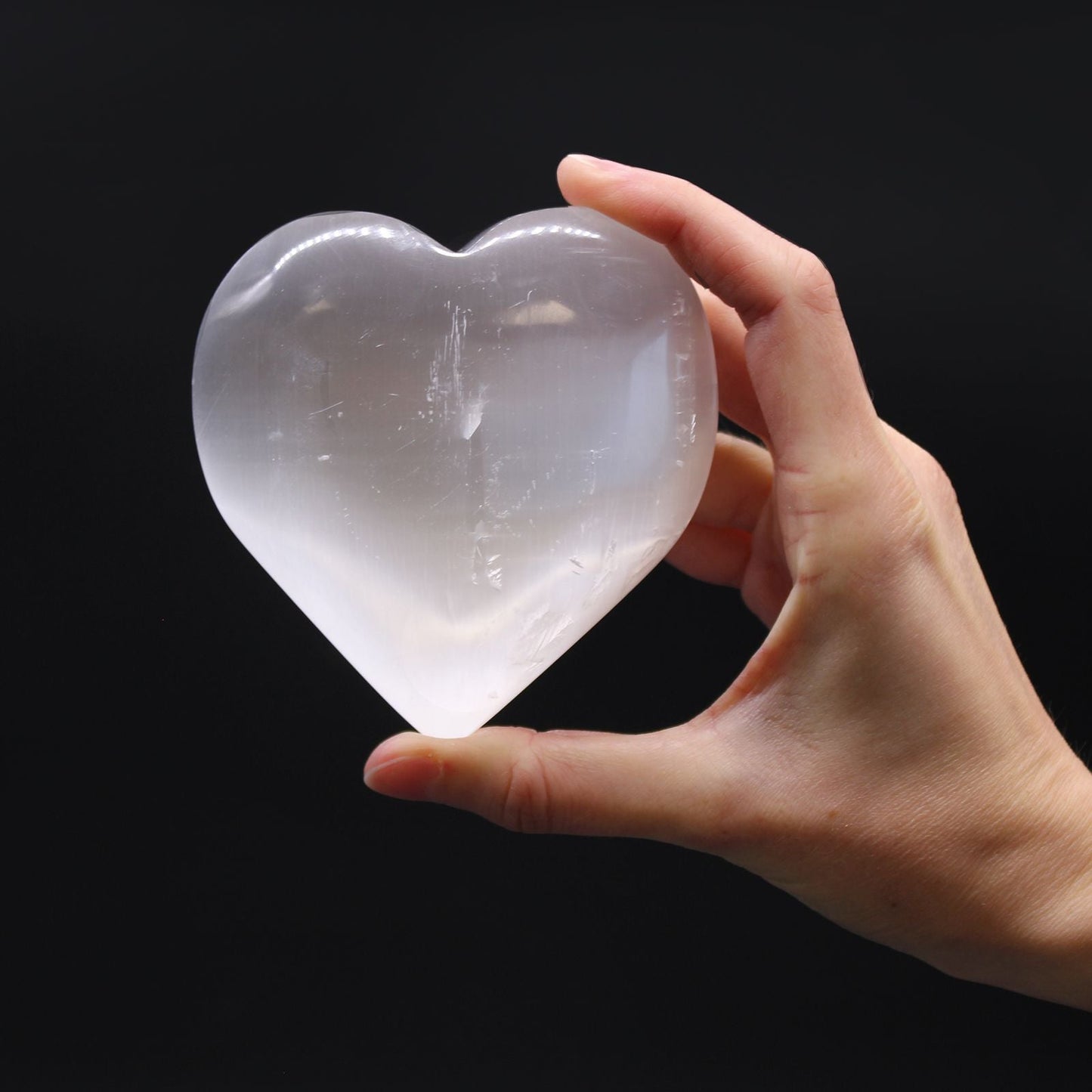 Radiant Selenite Heart – 10 CM heart-shaped selenite crystal held in hand, polished translucent stone decor piece