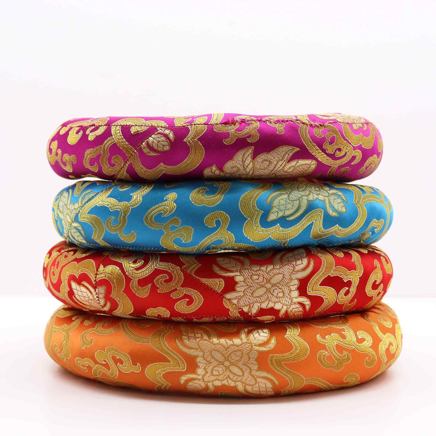 Alt Tag: Textile Polyester Hoop Cushion – 24CM brocade singing bowl ring cushion set, stacked in pink, blue, red and orange