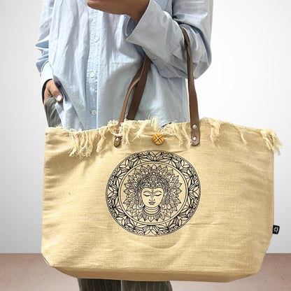 Alt Tag: 100% Cotton Tote Bag – Inspiration Print, Leather Handles beige canvas tote with leather straps and mandala face graphic, held by model