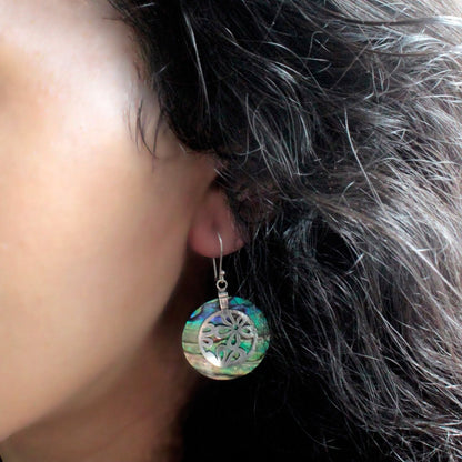 Abalone Shell & Silver Earrings – Classic Disc worn on ear, iridescent abalone disc with silver detail and hook earring