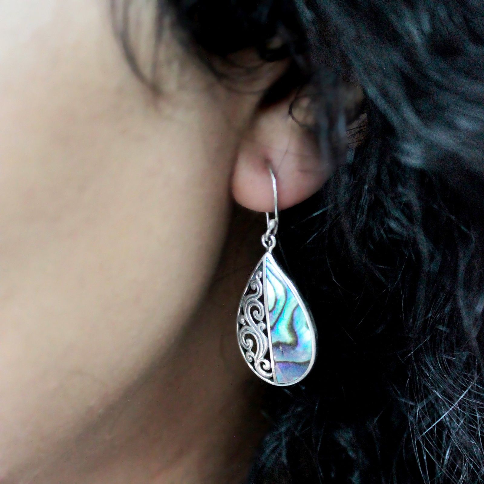 Alt Tag: Abalone Shell & Silver Earrings – Classic Disc worn on ear, iridescent abalone shell drop earring in silver setting