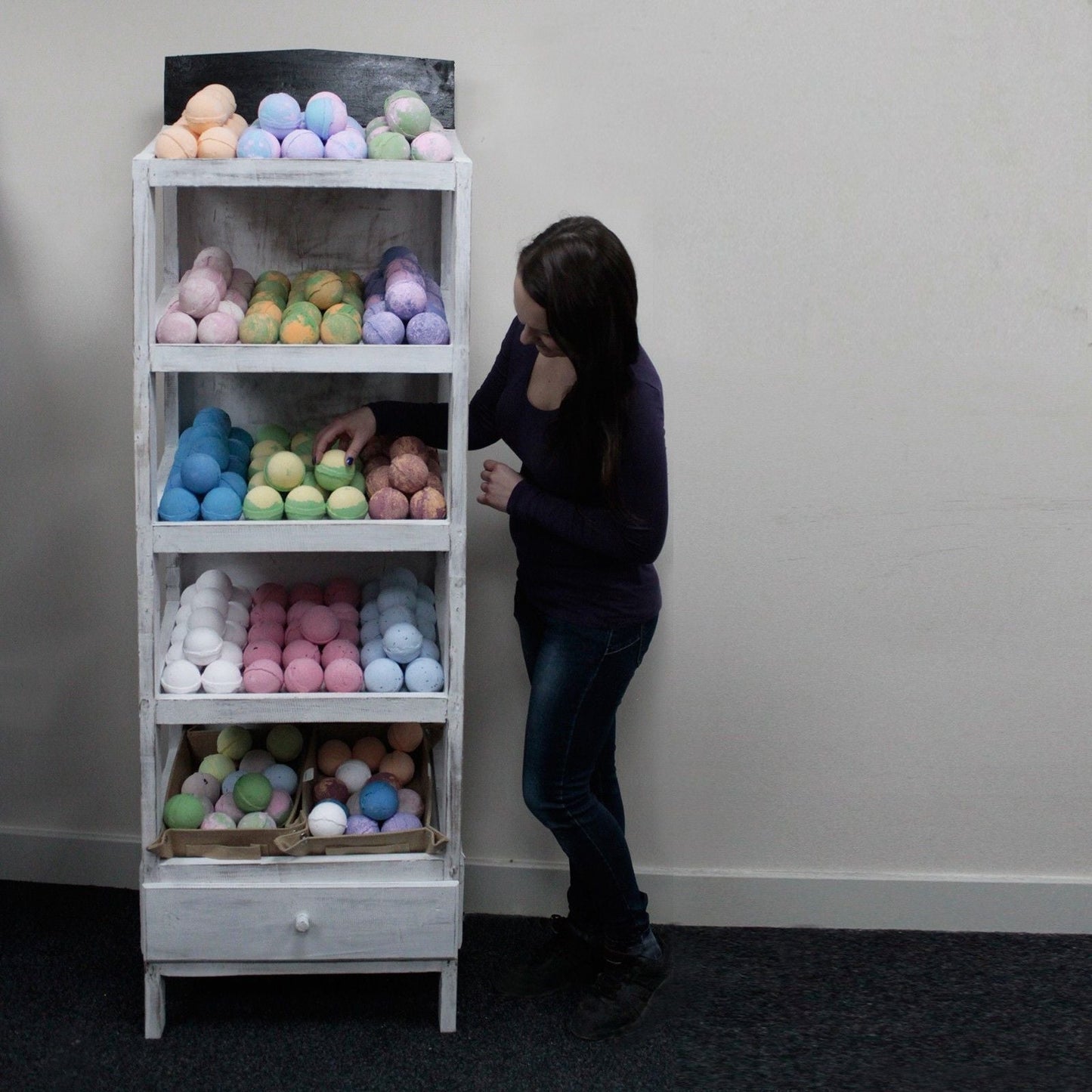 Alt Tag: Albasia Wood Retail Display Stand – 5 Shelves with bath bombs on five shelves in a retail setting