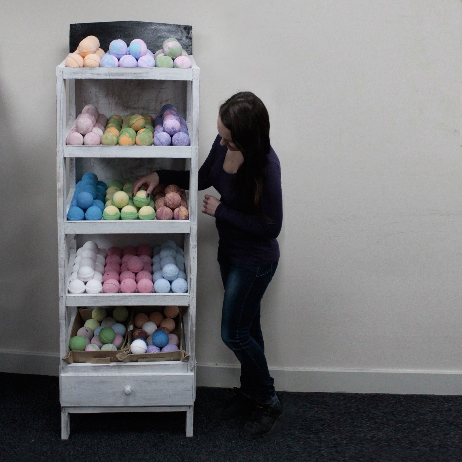 Alt Tag: Albasia Wood Retail Display Stand – 5 Shelves with bath bombs on five shelves in a retail setting