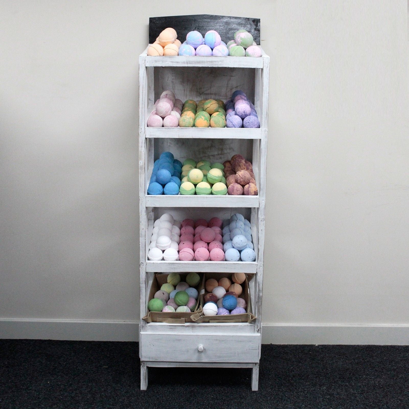 Albasia Wood Retail Display Stand – 5 Shelves with colorful bath bombs in a retail display rack