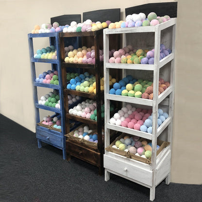 Alt Tag: Albasia Wood Retail Display Stand – 5 Shelves with colorful bath bombs on wooden shelving units in a retail store display