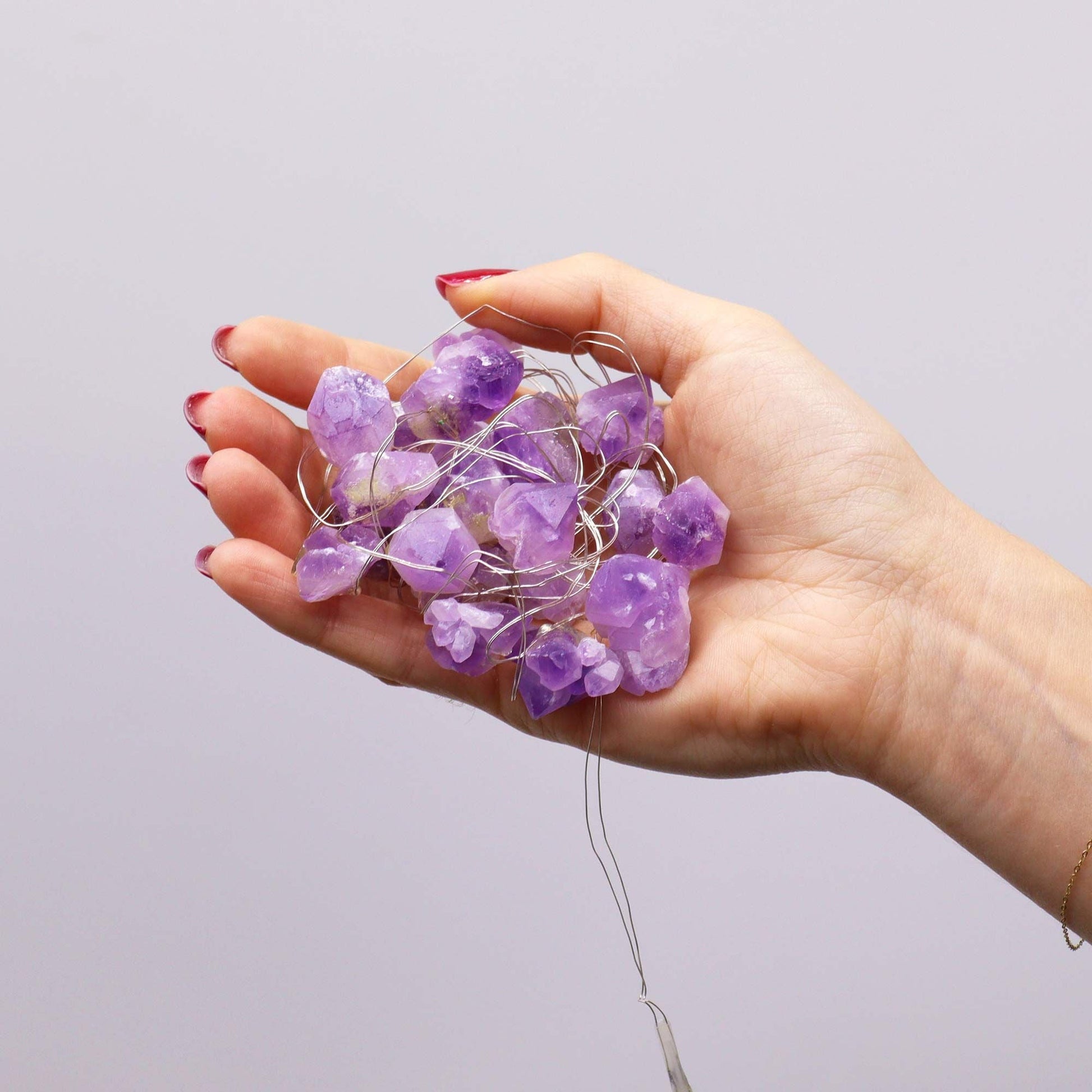 Amethyst Gemstone Enchantment Lights – Decorative String with genuine amethyst stones on warm LED wire lights in hand