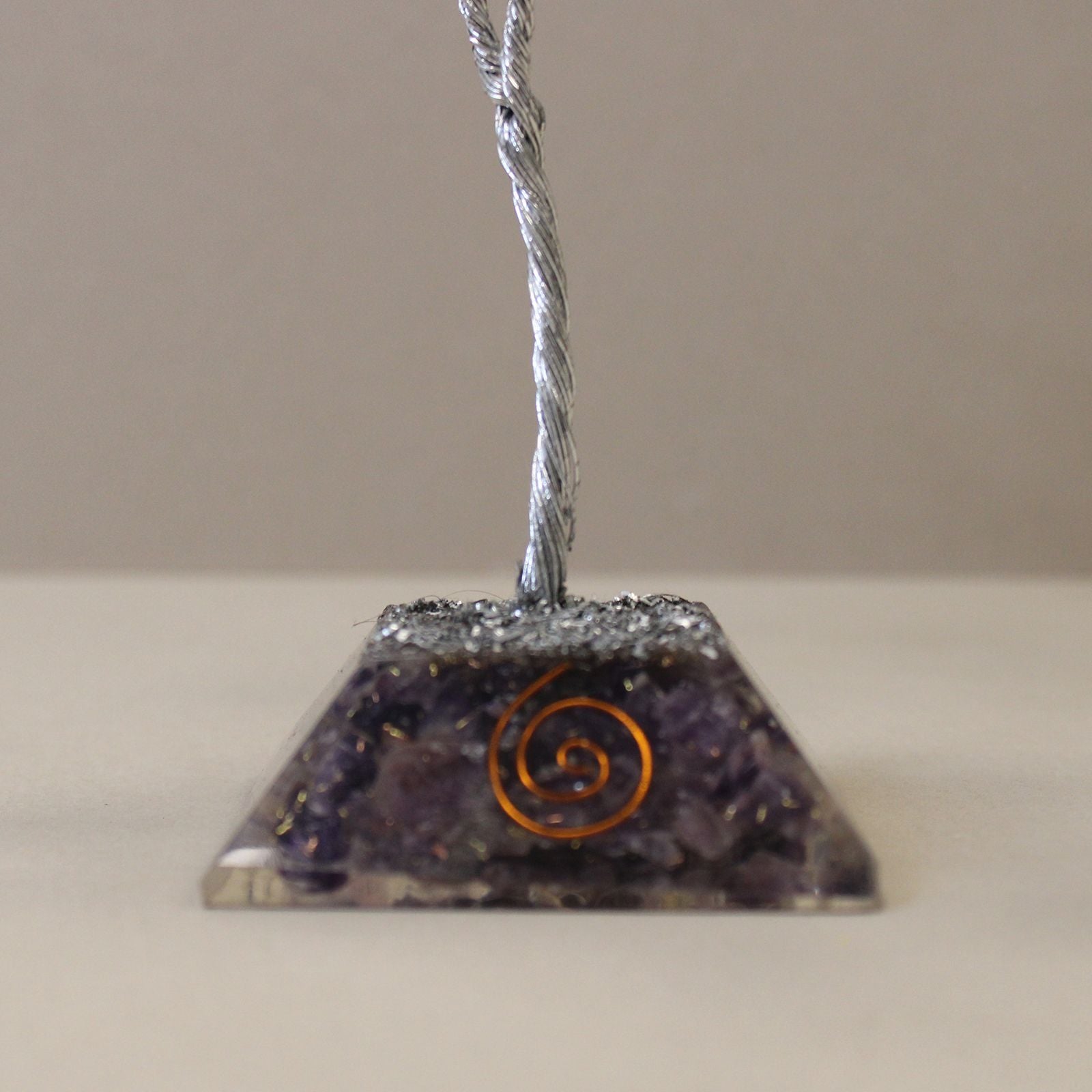 Amethyst Gemstone Tree – 80 Stones Orgonite Base close-up of purple orgonite pyramid base with copper spiral and metal wire trunk
