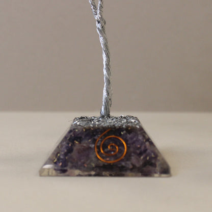 Amethyst Gemstone Tree – 80 Stones Orgonite Base close-up of purple orgonite pyramid base with copper spiral and metal wire trunk