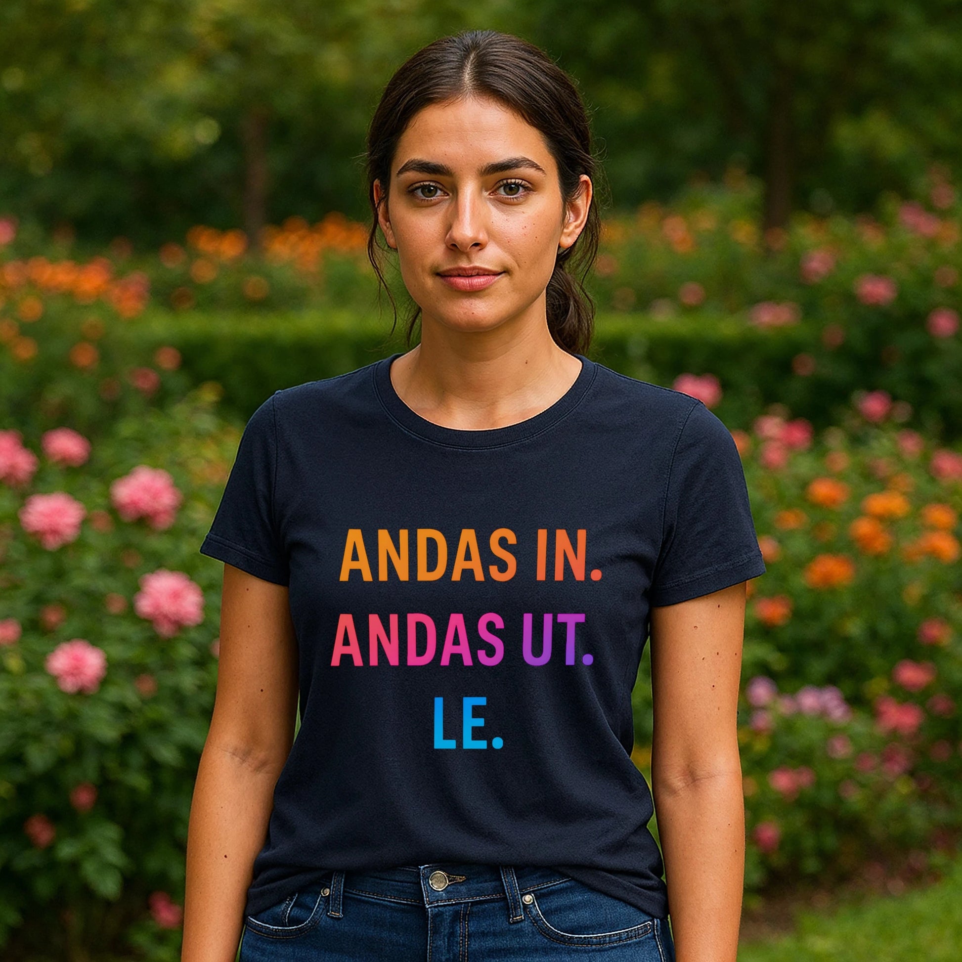 Andas Andas Ut Le Budskap 100% Organic Cotton T-Shirt navy graphic tee with colorful text, front view model outdoors