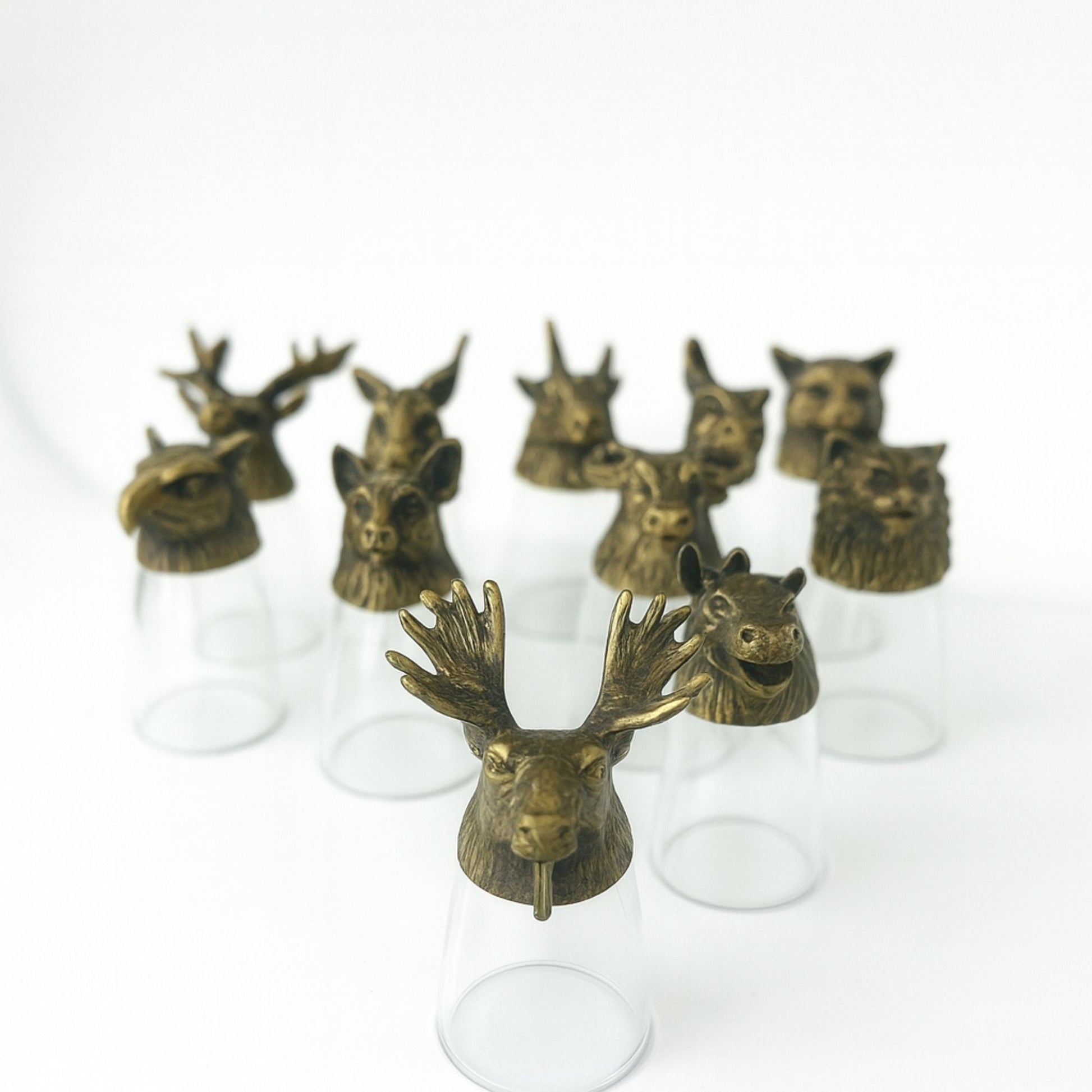 Alt Tag: Antique Bronze Shot Glasses – 25ML Set of 12, forest animal head brass tops on clear glass shot glasses