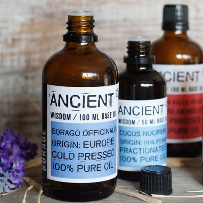 Apricot Kernel Base Oil – 50ML bottle of cold pressed base oil on wooden surface with other amber oil bottles