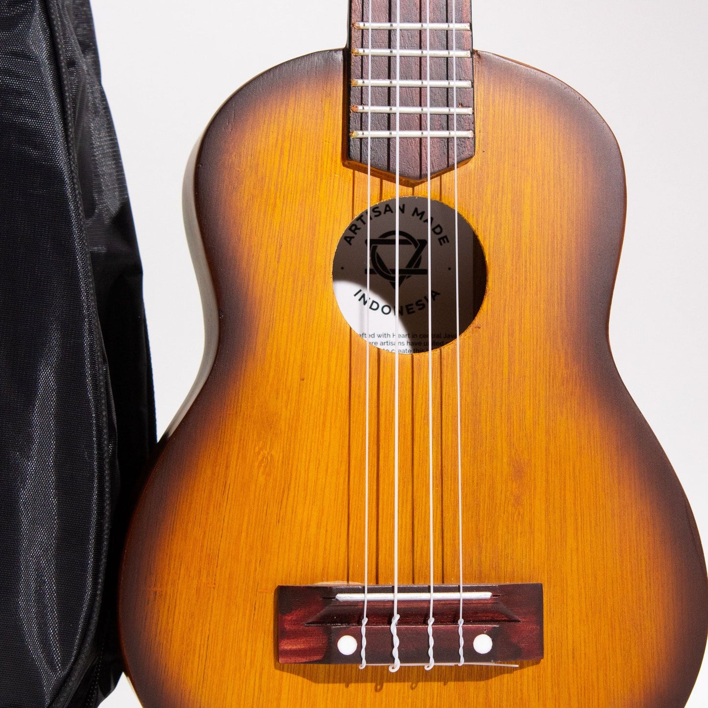 Alt Tag: Artisan Made Ukulele – Orange Sunburst Finish (4 String) close-up, 4-string handcrafted wooden body with orange-to-amber sunburst
