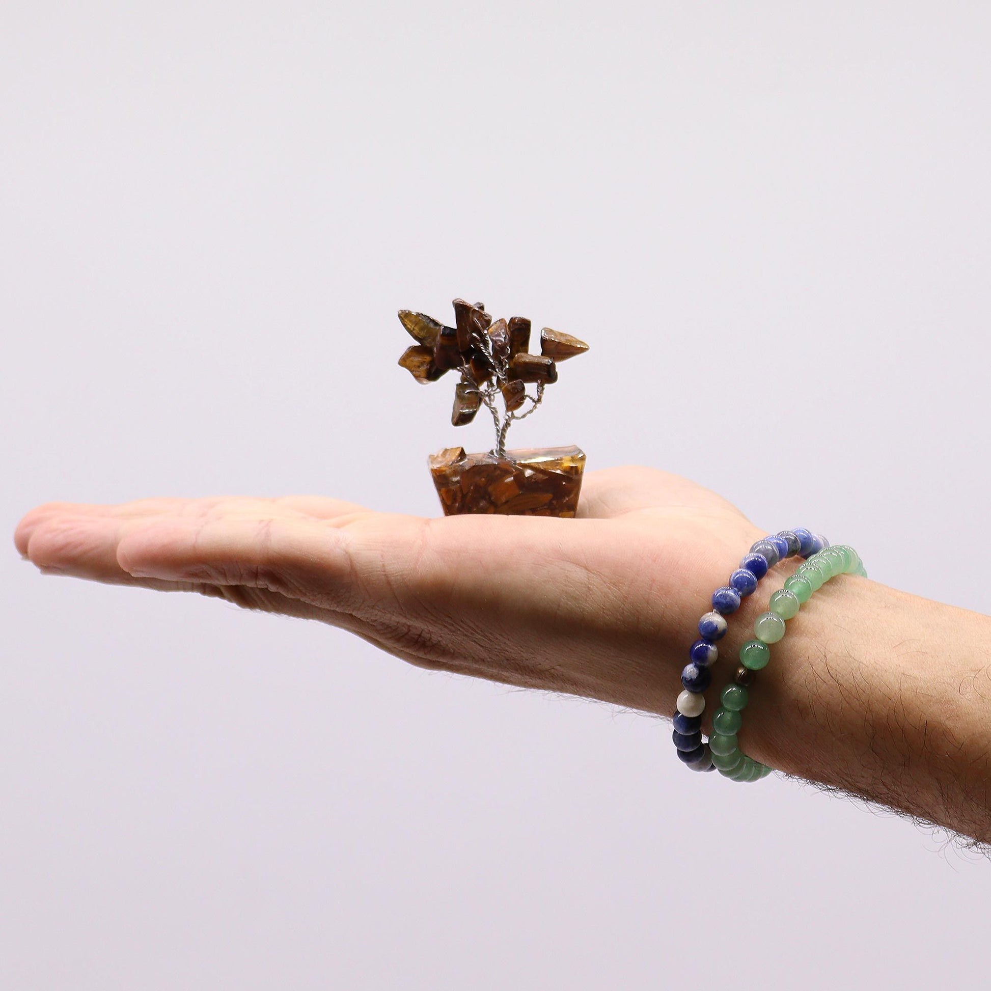 Assorted Mini Gemstone Trees – Orgonite Base Set of 12 mini gemstone tree with orgonite base on hand, beaded bracelets