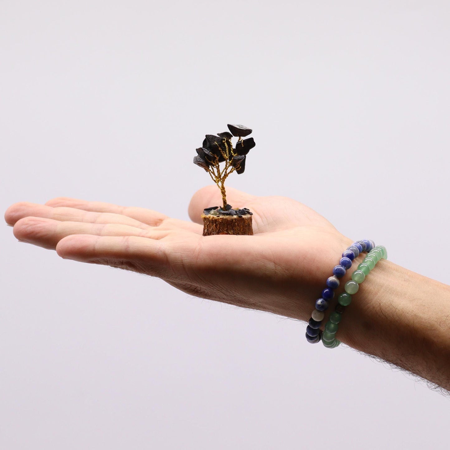 Assorted Mini Gemstone Trees – Wood Base, 15 Stones mini gemstone tree on wood base displayed on an open hand