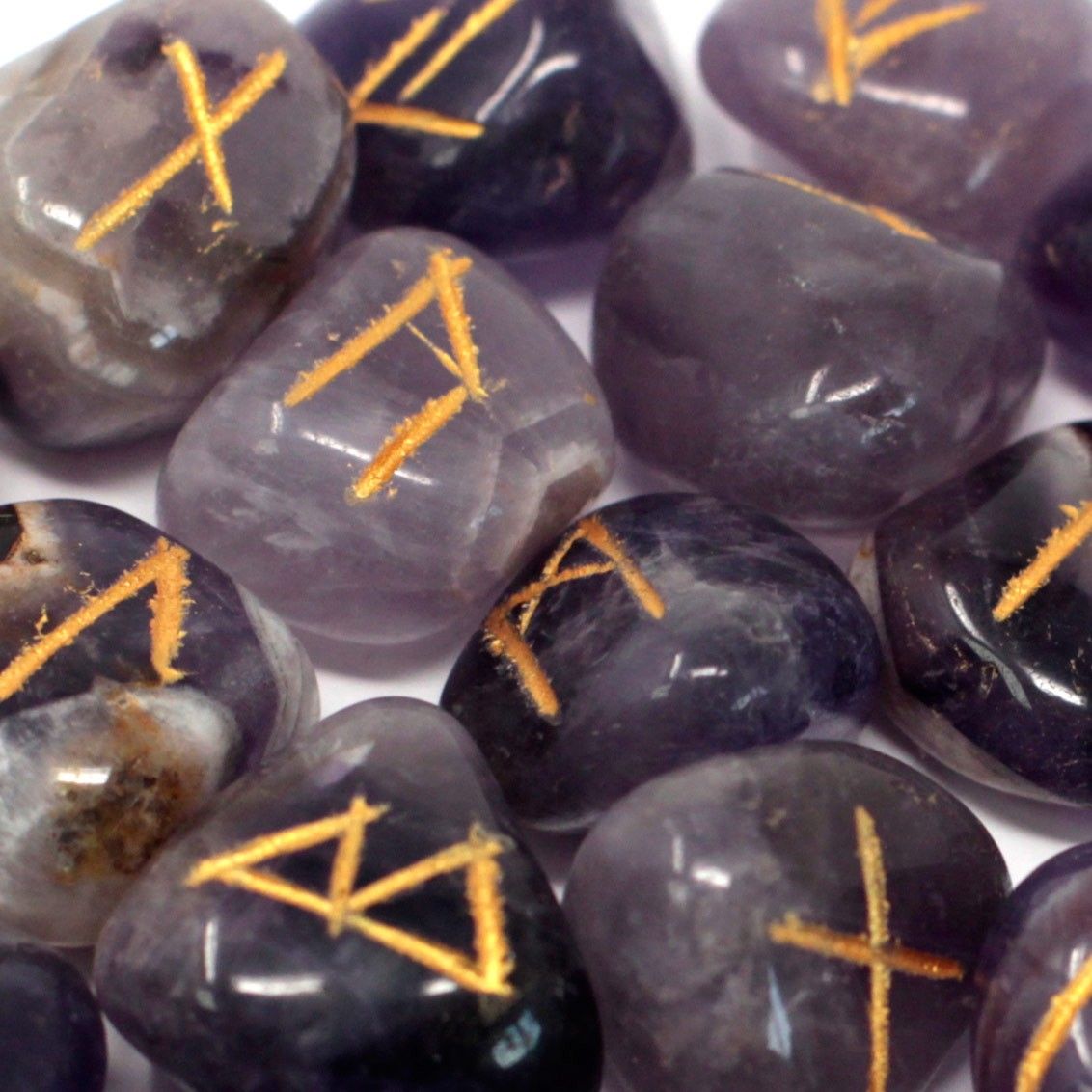 Mystical amethyst rune set from India, 25 engraved stones with rune symbols, including one blank rune, in pouch