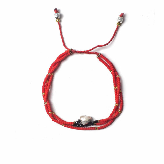 Unconditional Love temple string bracelet with red heart charm, handmade in Indonesia, adjustable red cord with beads and metal