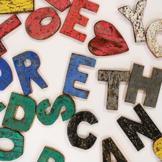 Rustic bark letter wall art reading “I love you more than words can say” in natural wood-style lettering