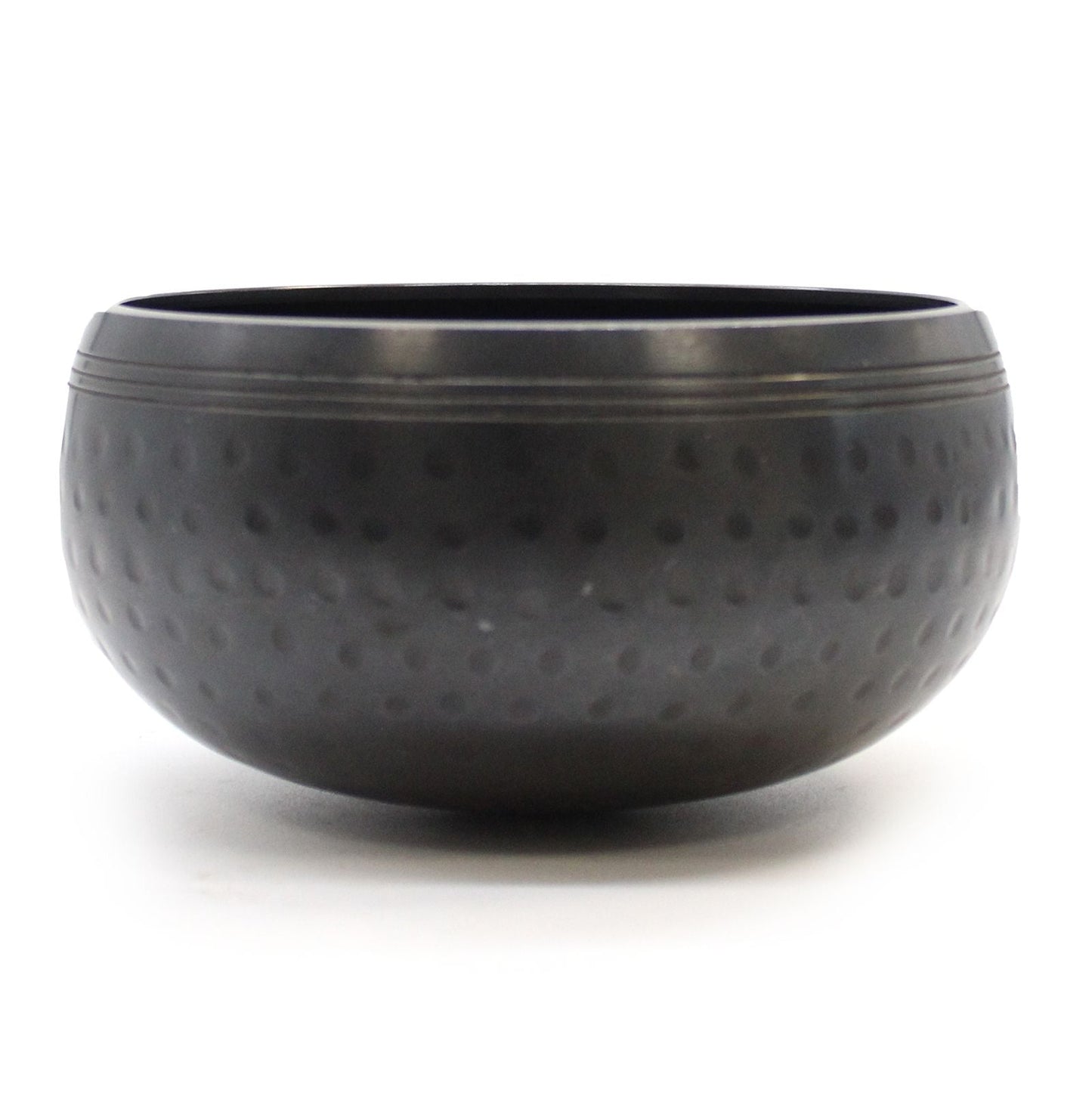 Small black beaten singing bowl, 14cm diameter and 8cm height, used for meditation and prayer