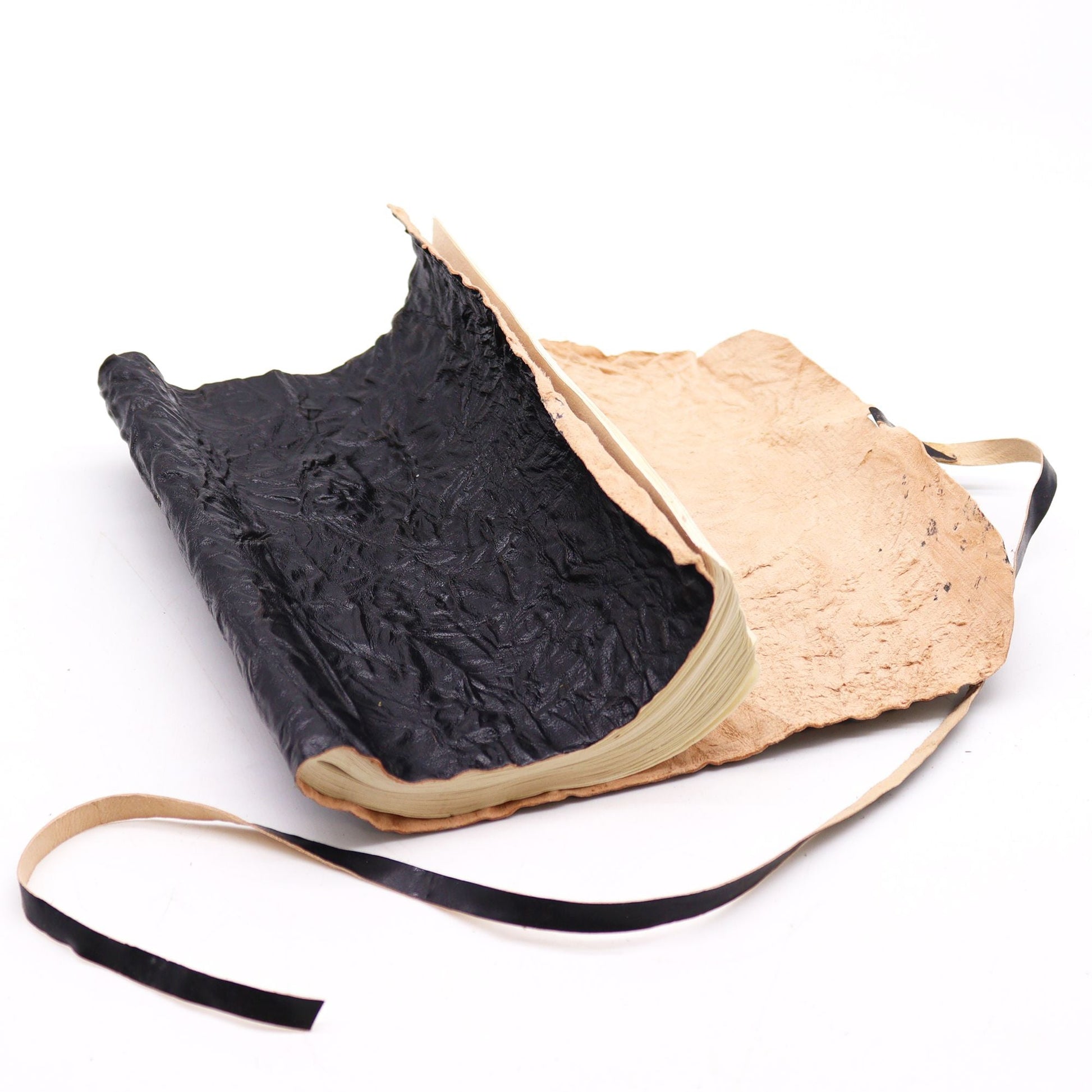 Handmade black rolled leather travel notebook with wrap tie closure, 96 unlined pages, 21x15 cm