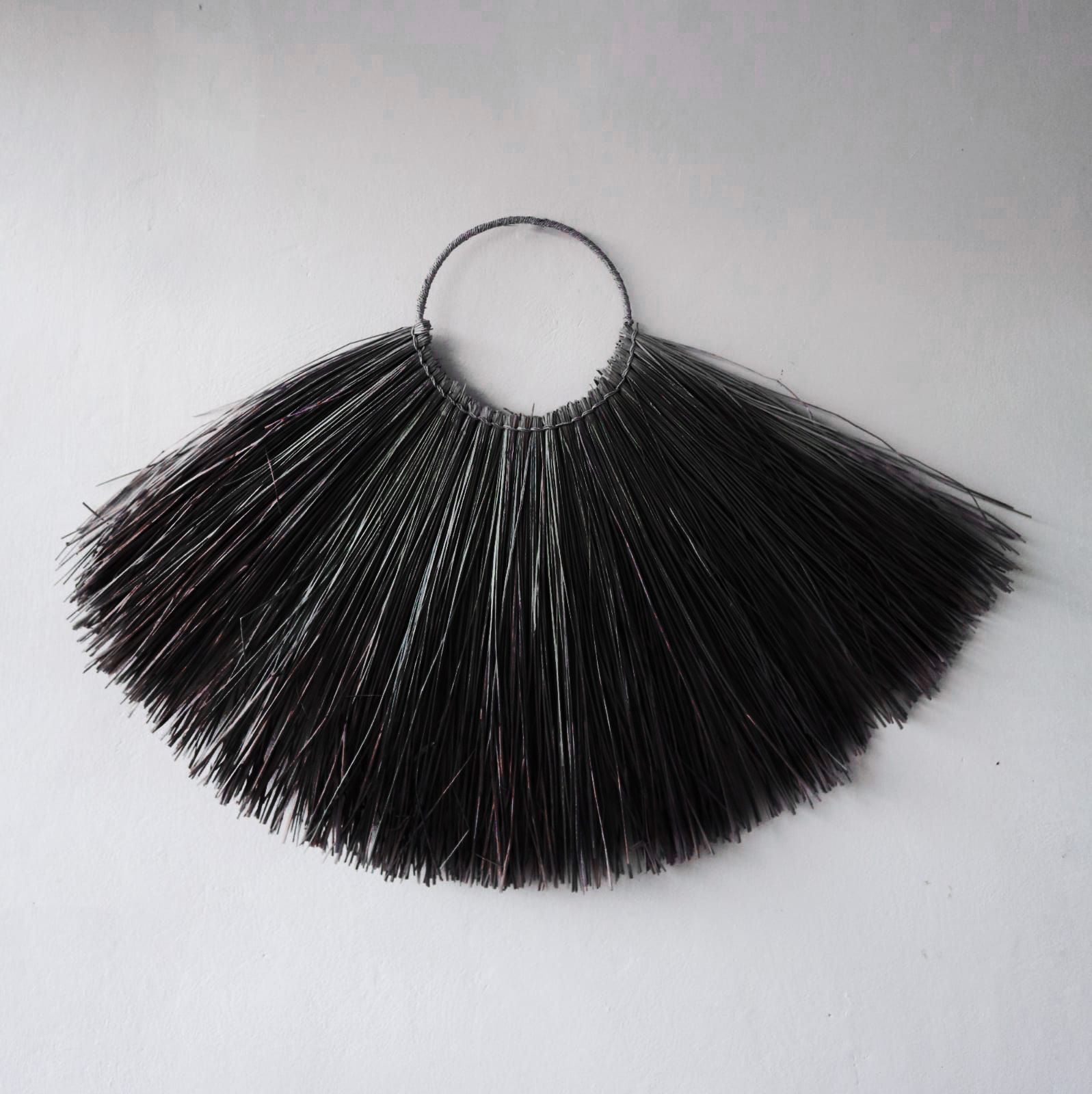 Large black seagrass fan wall decor with woven texture, bold boho statement accent for living room or bedroom