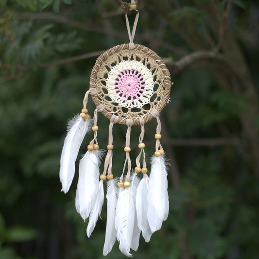 Pastel pink 12cm macramé dream catcher handmade in Bali with cotton and feathers, available in assorted colour variations.