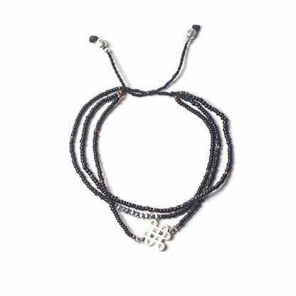 Black endless knot temple string bracelet with metal charm and beads, adjustable unisex spiritual grounding jewelry
