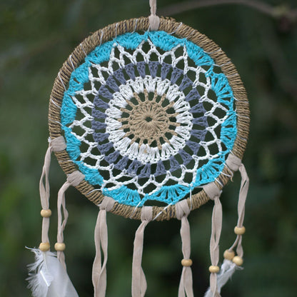 Pastel blue 16cm macramé dream catcher handmade in Bali with cotton, web detail and feathers, assorted colour variations.