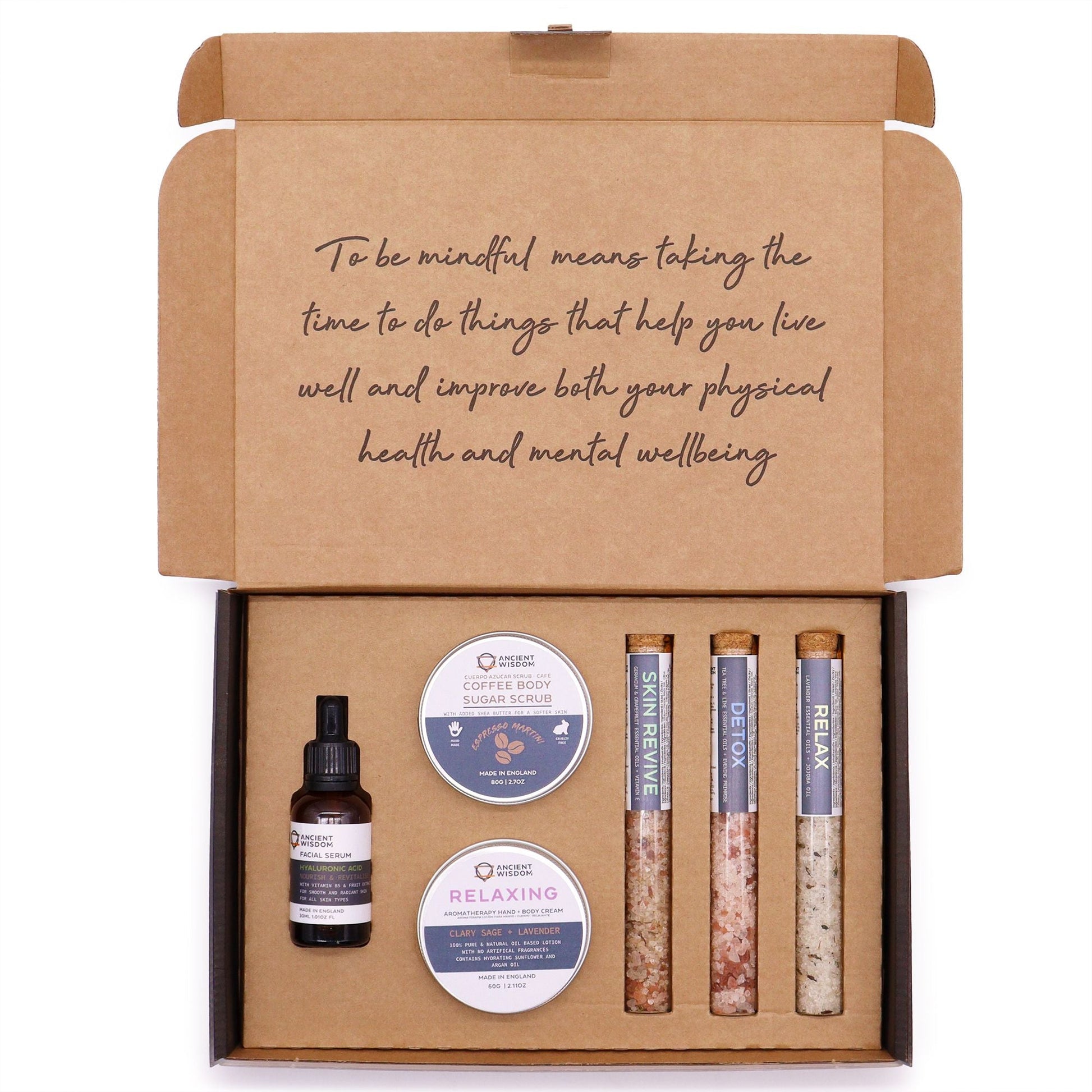 Mindful Moments self care kit with coffee sugar scrub, body cream, three bath salts vials, and hyaluronic acid serum