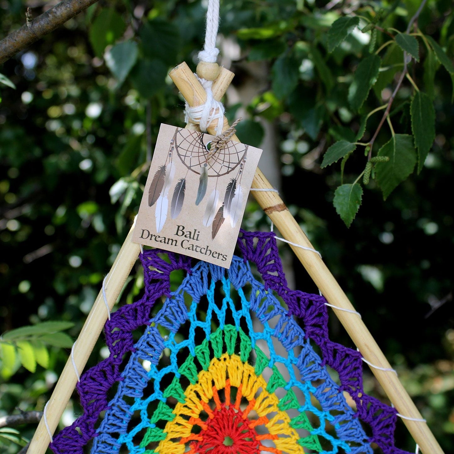 Synthetic Suede Pyramid Dream Catcher – 90 CM multicolor woven pyramid dreamcatcher with feathers and wooden beads hanging outdoors