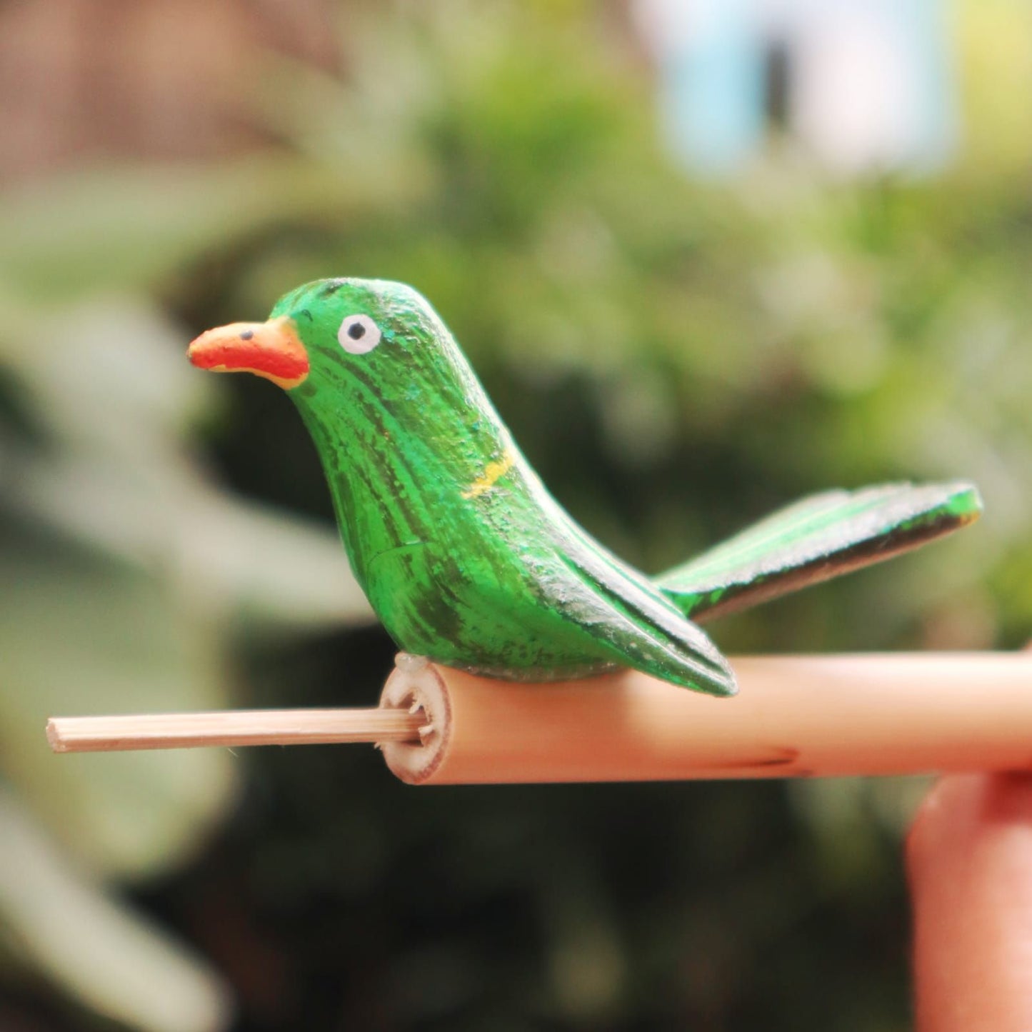 Alt Tag: Bamboo Bird Whistle – 13x5x1 CM green bird-shaped bamboo whistle, portable outdoor accessory close-up