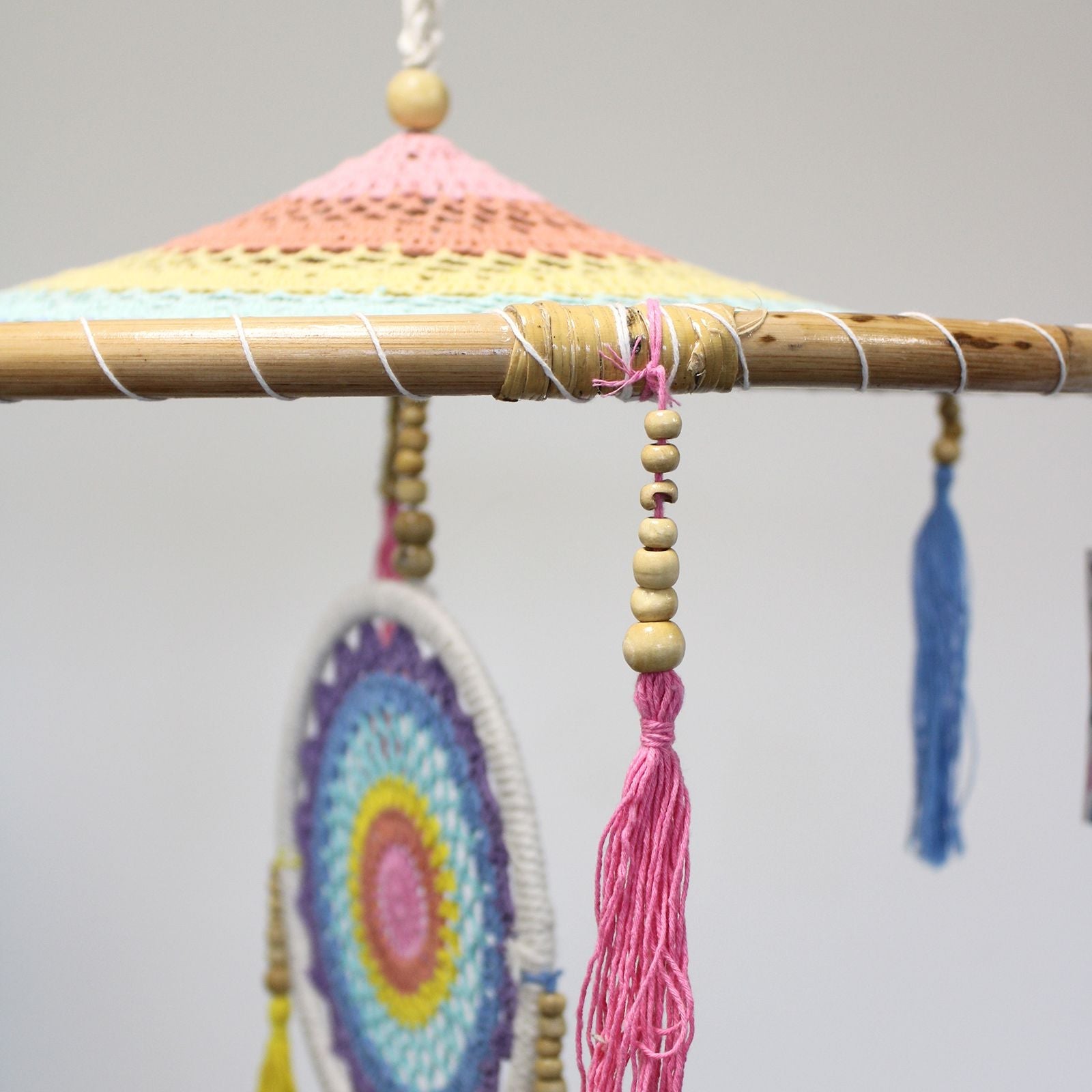 Alt Tag: Bamboo & Cotton Rainbow Dreamcatcher – 140 CM close-up of bamboo hoop with pastel crochet top, beads and pink tassel