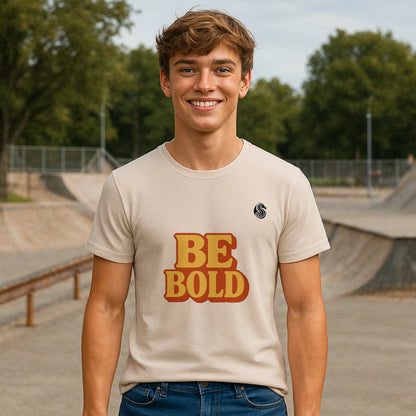 Alt Tag: Be Bold Youth 100% Organic Cotton T-Shirt with "BE BOLD" graphic, youth model wearing cream tee at skatepark