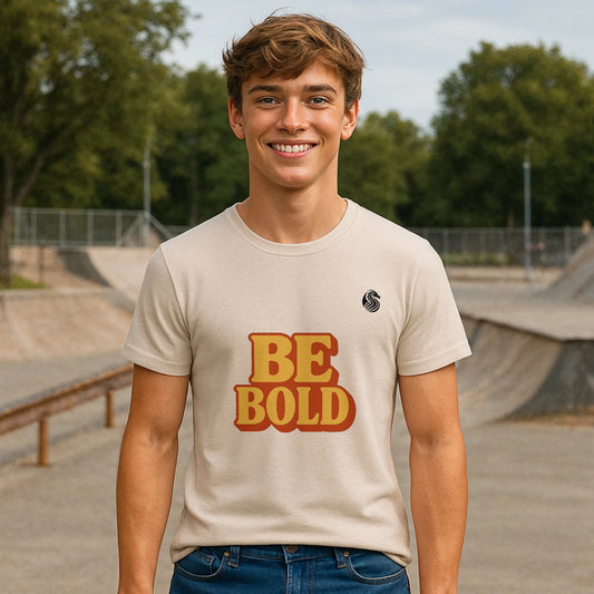 Alt Tag: Be Bold Youth 100% Organic Cotton T-Shirt with "BE BOLD" graphic, youth model wearing cream tee at skatepark