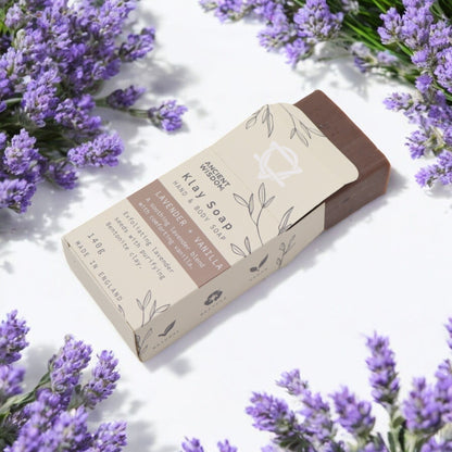 Alt Tag: Bentonite Clay Soap – Lavender & Vanilla 145G bar soap in box with lavender flowers on white background