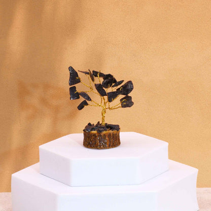 Black Agate Mini Gemstone Tree – 6CM, 15 Stones on white display pedestal, gold wire branches with polished black agate chips