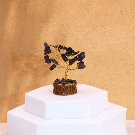 Black Agate Mini Gemstone Tree – 6CM, 15 Stones on white display pedestal, gold wire branches with polished black agate chips