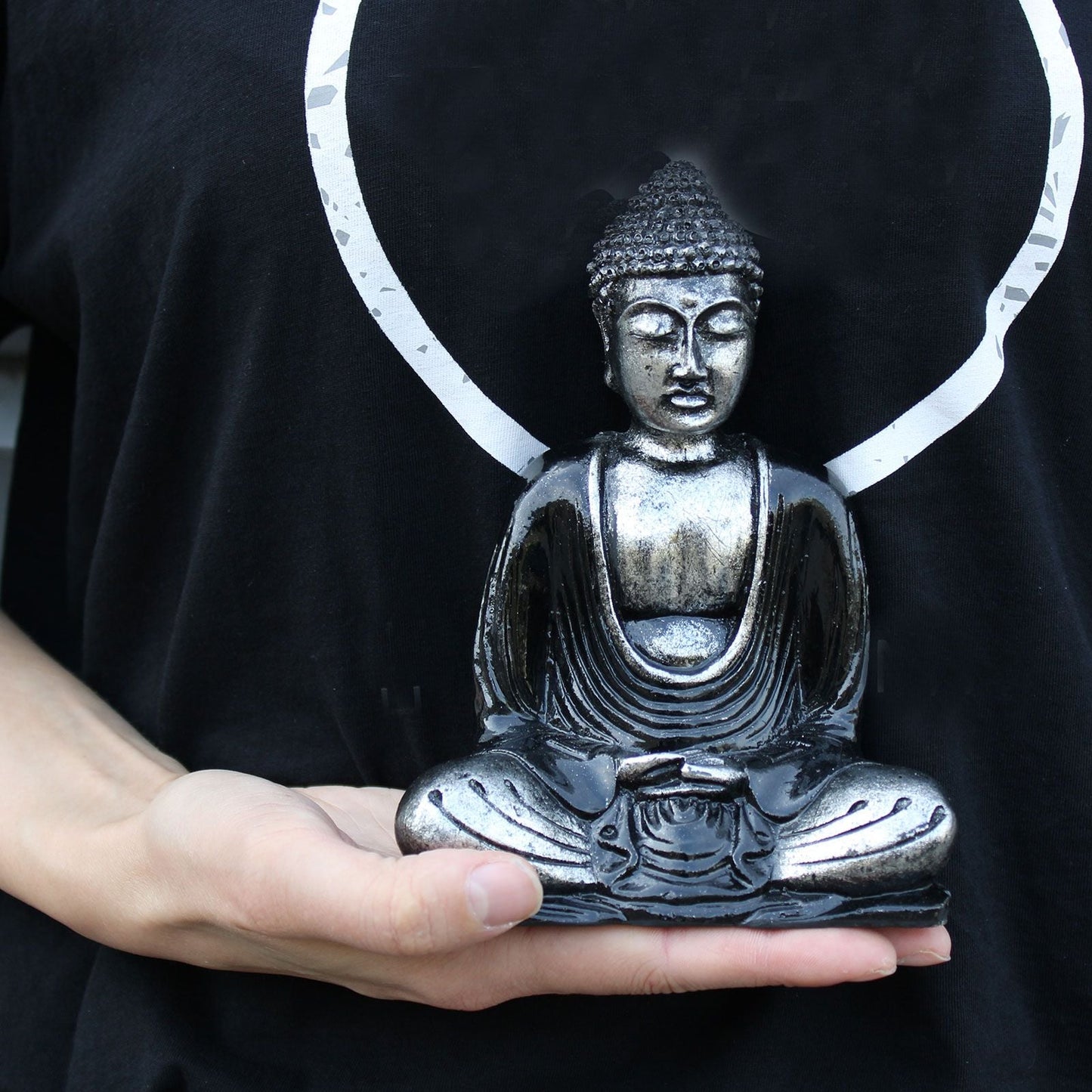 Black & Grey Buddha Statue – Medium seated meditation figurine with modern black and grey finish, displayed on hand