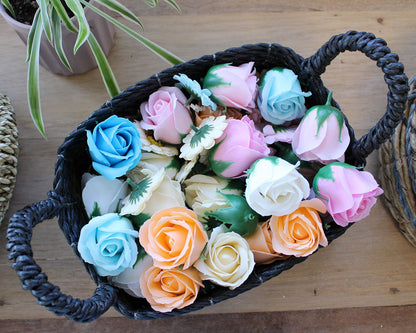 Banana Leaf & Seagrass Basket Set – 3 Sizes black handwoven basket filled with colorful artificial roses on wooden table