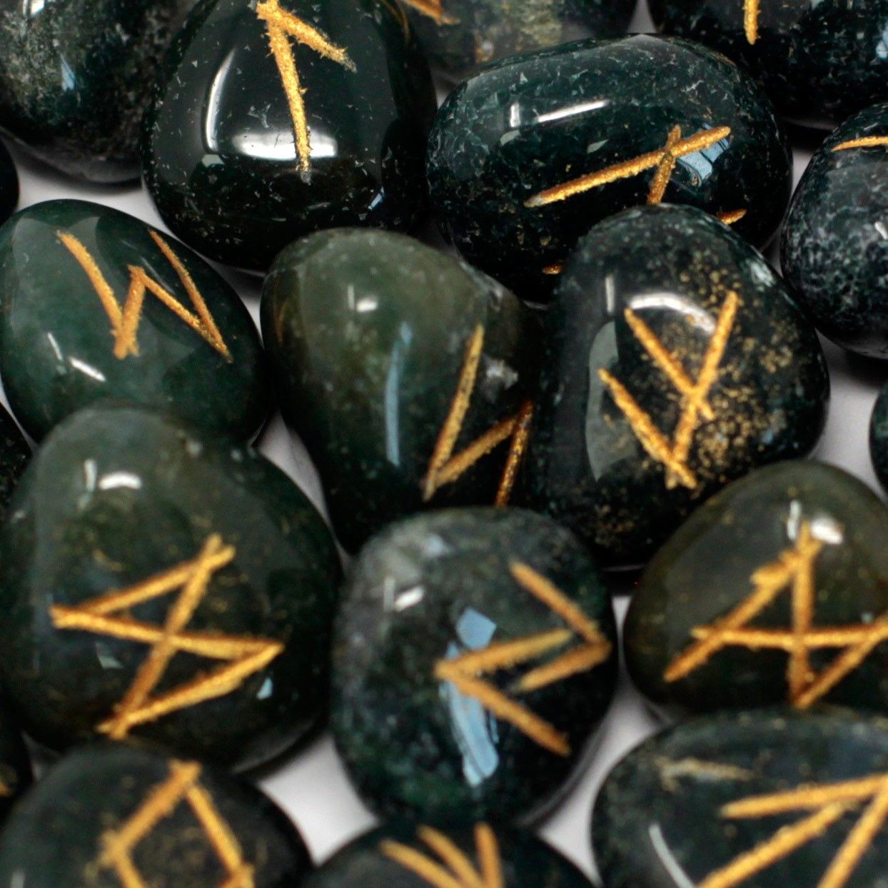 Alt Tag: Bloodstone Rune Stone Set – 25 Pieces with Pouch, engraved bloodstone rune stones with gold symbols, close-up with cotton pouch